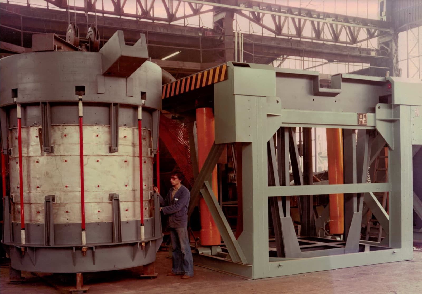 A CIME coreless induction furnace pouring molten iron, melting the metal with a magnetic field and no flame