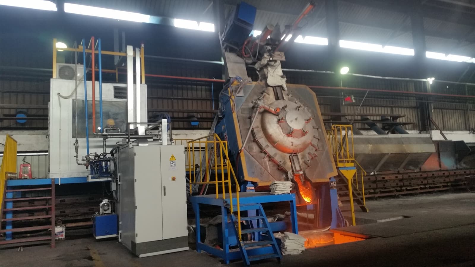 A CIME coreless induction melting furnace on its tilting frame, the coil that heats the whole bath evenly