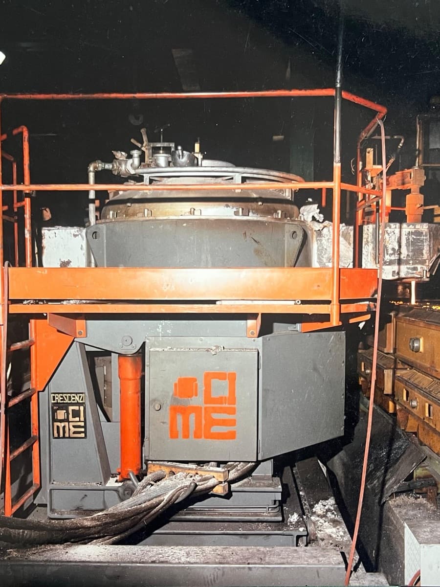 A CIME CAP press-pouring furnace installed on a foundry floor beside sand moulds waiting to be filled with ductile iron
